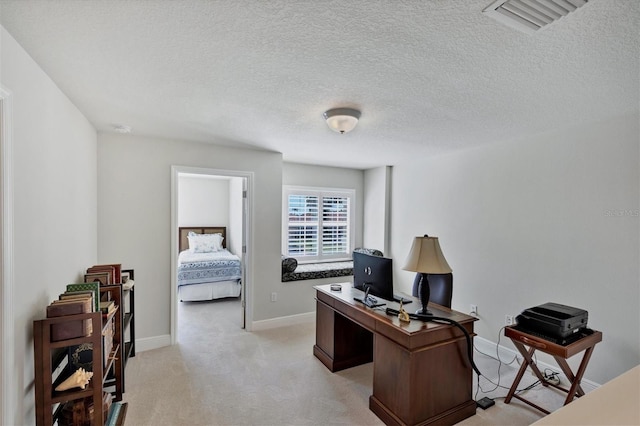 carpeted office with a textured ceiling