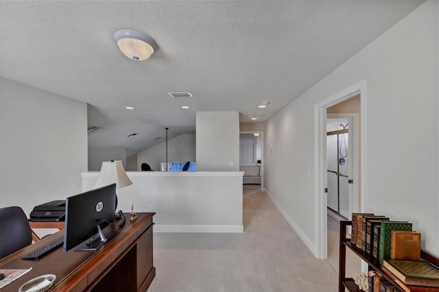 carpeted office with lofted ceiling and a textured ceiling