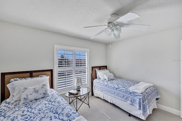 carpeted bedroom featuring a textured ceiling and ceiling fan