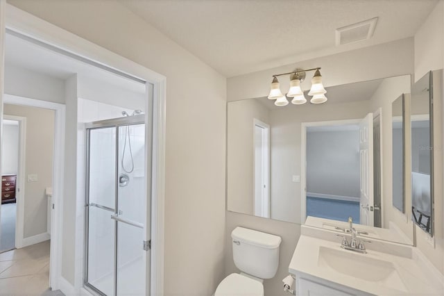 bathroom featuring vanity, walk in shower, tile patterned flooring, an inviting chandelier, and toilet