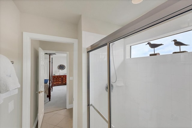 bathroom with a shower with shower door and tile patterned floors