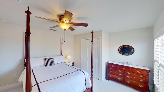 carpeted bedroom featuring ceiling fan and a closet