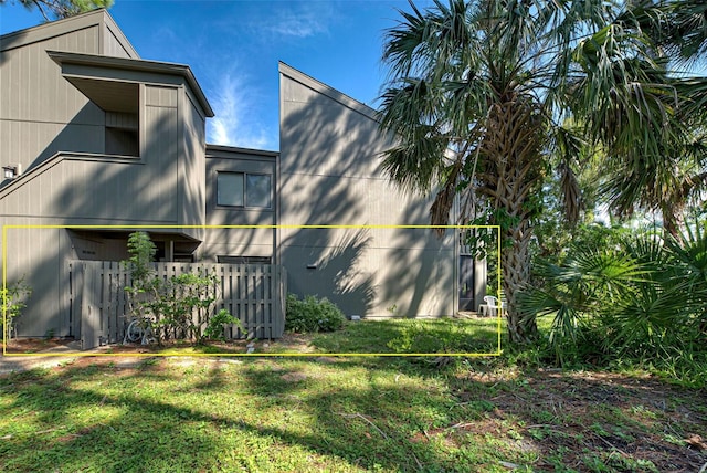 view of side of home featuring a yard