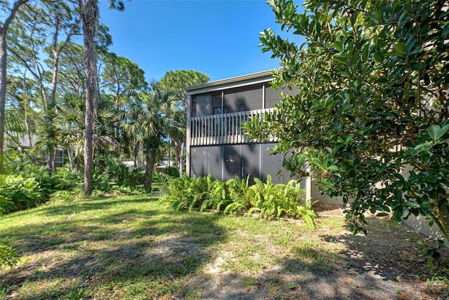 201 Woodland Dr Unit 201, Osprey, FL 34229 - view of green lawn featuring a sunroom