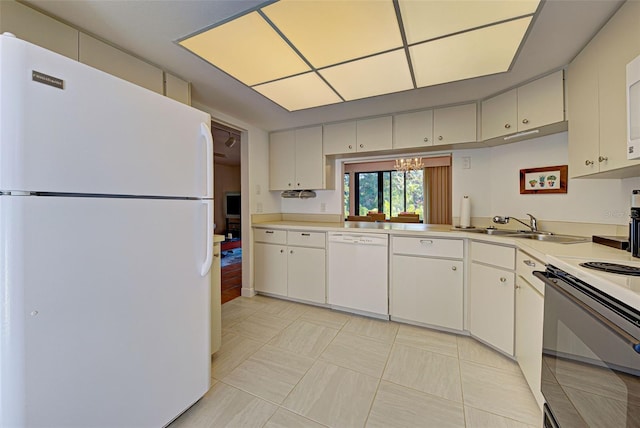 kitchen with a notable chandelier, white appliances, sink, and white cabinets