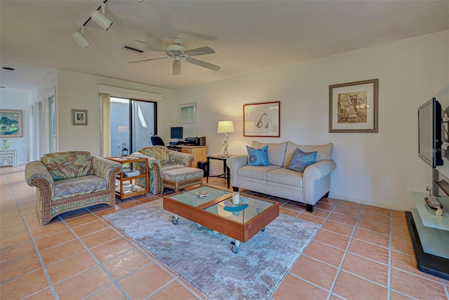 tiled living room featuring ceiling fan and rail lighting