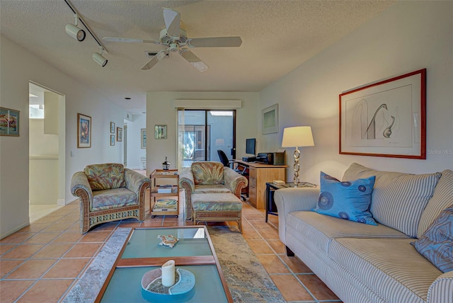 living room featuring ceiling fan, a textured ceiling, track lighting, and light tile patterned floors