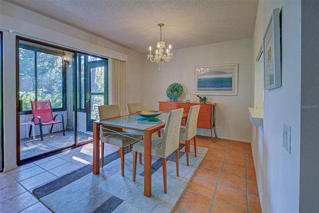 dining room with light tile patterned floors, a textured ceiling, and a chandelier