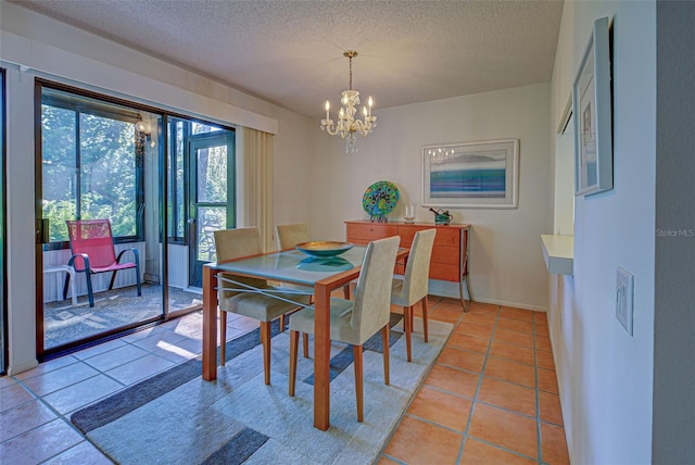 201 Woodland Dr Unit 201, Osprey, FL 34229 - dining space featuring a chandelier, a textured ceiling, light tile patterned floors, and baseboards