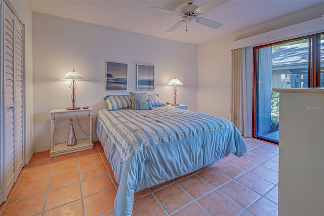 tiled bedroom featuring ceiling fan, a textured ceiling, a closet, and access to outside