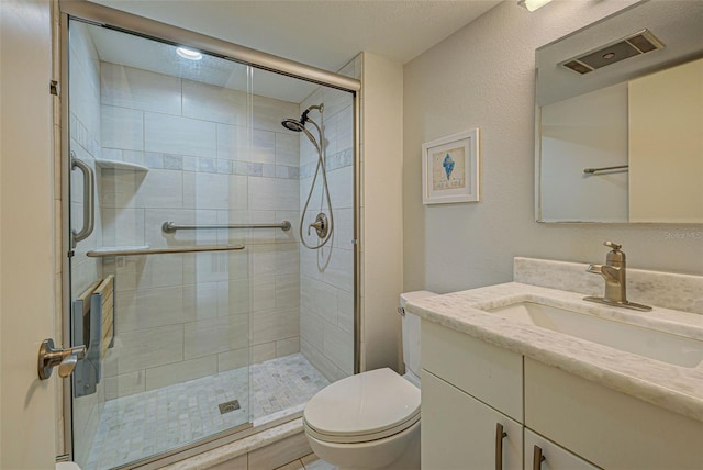 bathroom with walk in shower, vanity, and toilet