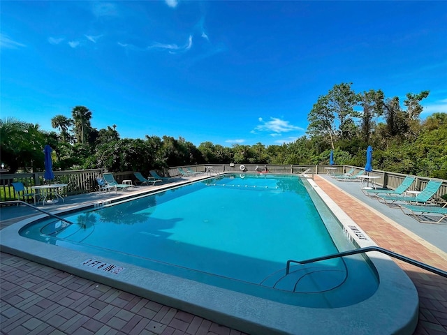 201 Woodland Dr Unit 201, Osprey, FL 34229 - community pool featuring a patio area and view of scattered trees