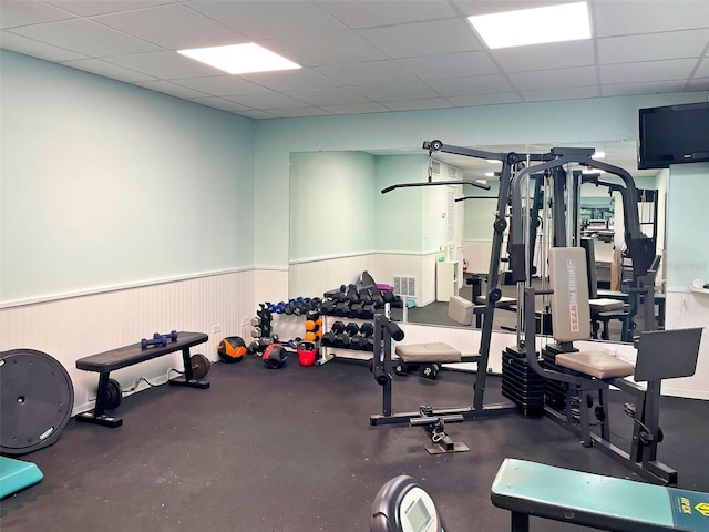 201 Woodland Dr Unit 201, Osprey, FL 34229 - gym featuring a wainscoted wall and a drop ceiling