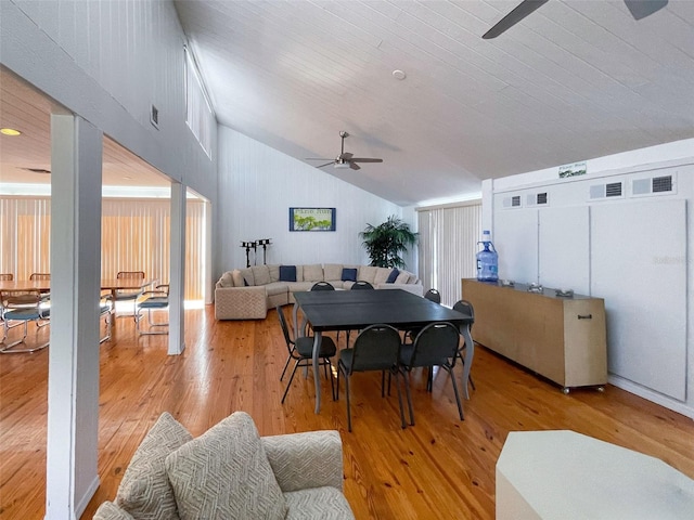 dining room featuring light wood-type flooring, lofted ceiling, and ceiling fan