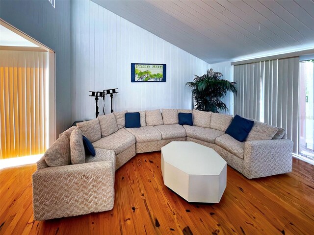 201 Woodland Dr Unit 201, Osprey, FL 34229 - living room with vaulted ceiling, healthy amount of natural light, wood finished floors, wood ceiling, and wooden walls