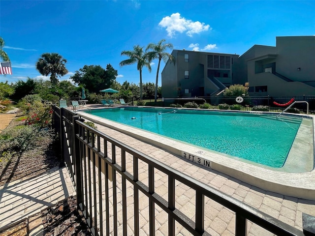 view of swimming pool with a patio area