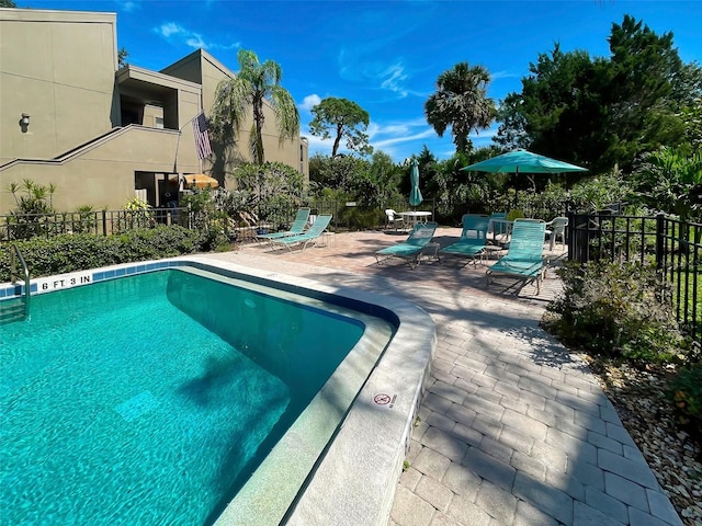 view of swimming pool featuring a patio area