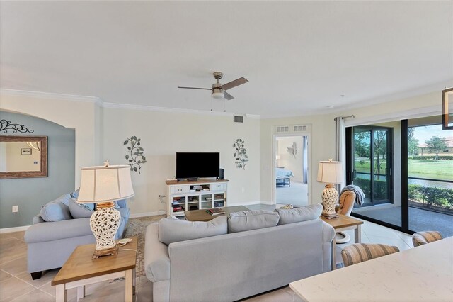 living room with ceiling fan, crown molding, and light tile patterned floors