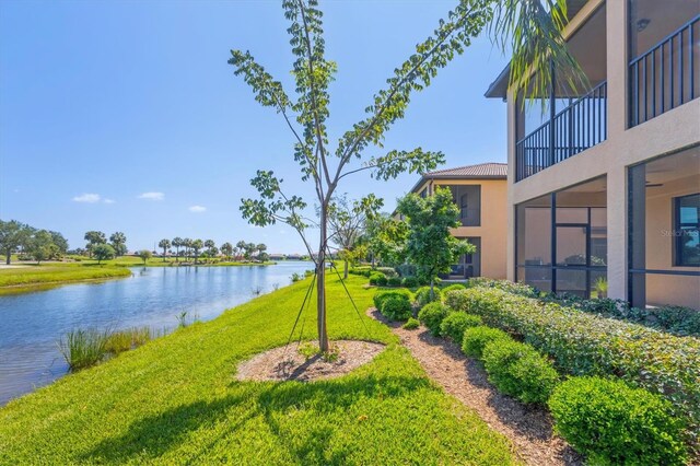 view of yard with a water view and a balcony