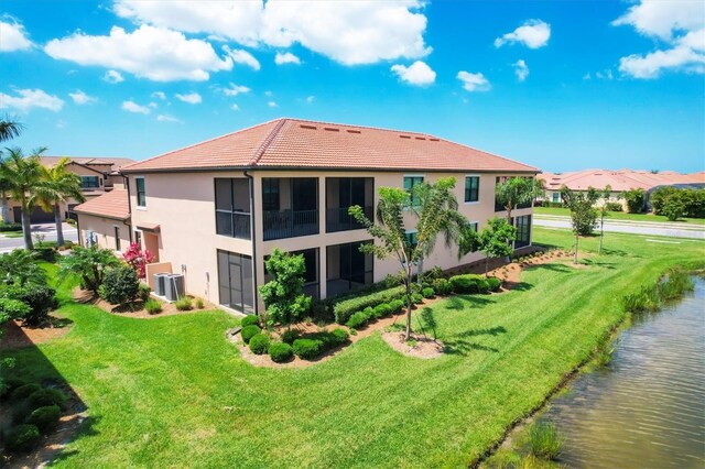 rear view of property featuring a yard and a water view