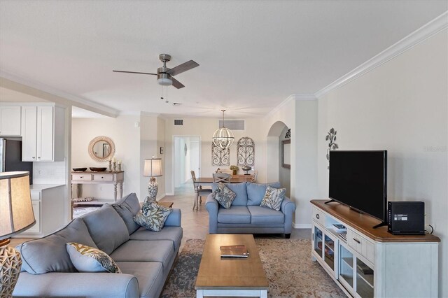 living room featuring crown molding and ceiling fan