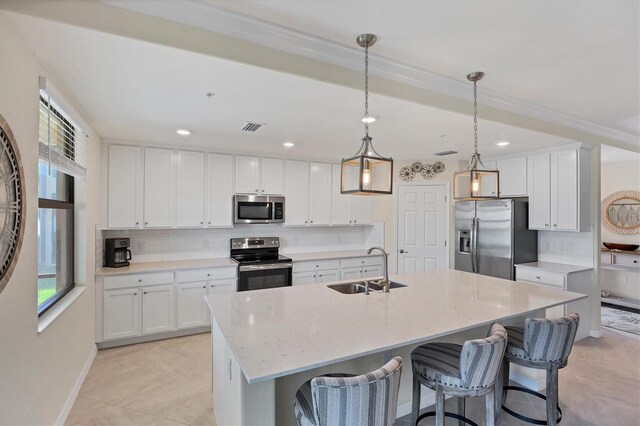 kitchen featuring white cabinets, stainless steel appliances, decorative light fixtures, and a healthy amount of sunlight