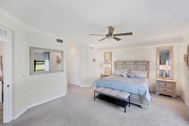 carpeted bedroom with ornamental molding, ceiling fan, and a closet