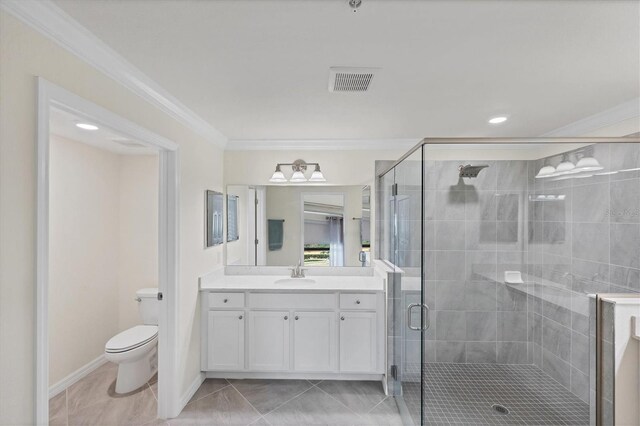 bathroom with vanity, crown molding, tile patterned flooring, a shower with shower door, and toilet