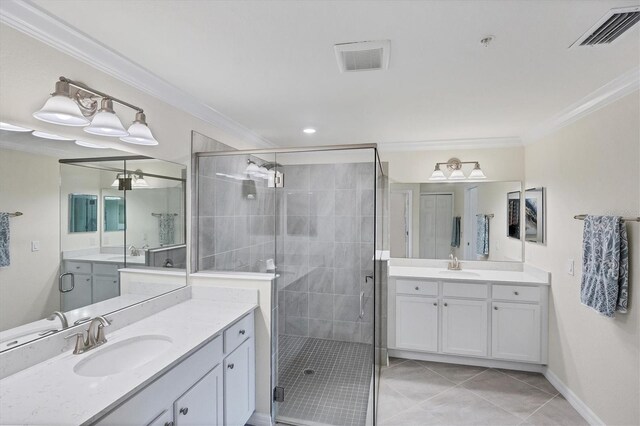 bathroom with tile patterned flooring, ornamental molding, a shower with shower door, and vanity