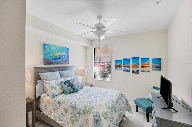 bedroom with ceiling fan and light colored carpet