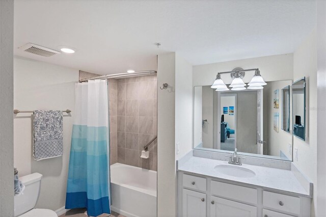 full bathroom featuring vanity, shower / tub combo, and toilet