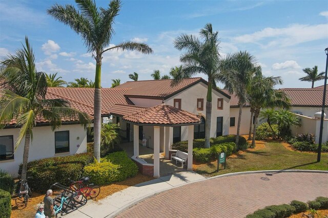 mediterranean / spanish-style house with a front lawn