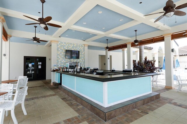 kitchen featuring a large fireplace, beamed ceiling, and coffered ceiling