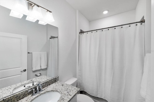 bathroom featuring vanity, toilet, and a shower with curtain