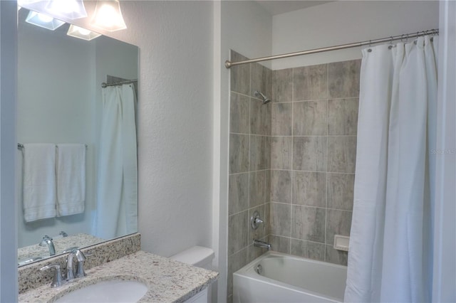 full bathroom featuring toilet, vanity, and shower / bathtub combination with curtain