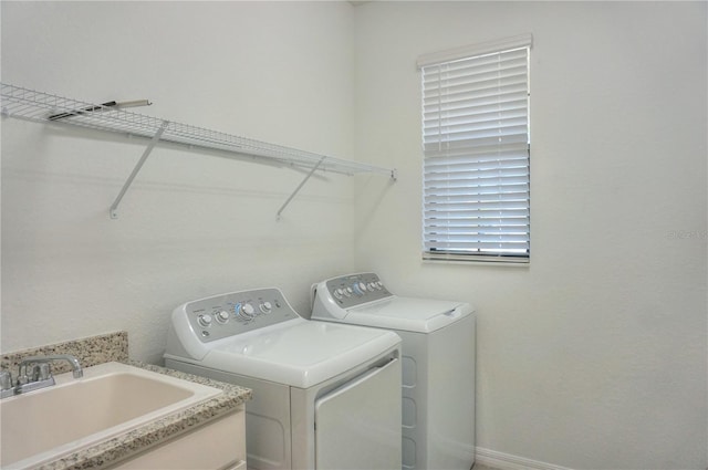 clothes washing area featuring washer and dryer and sink