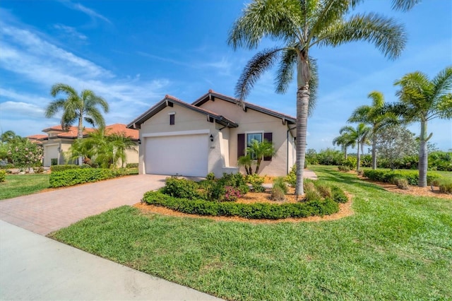 view of front of property featuring a garage and a front yard