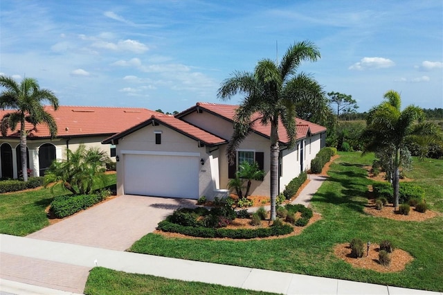 mediterranean / spanish home with a front yard and a garage