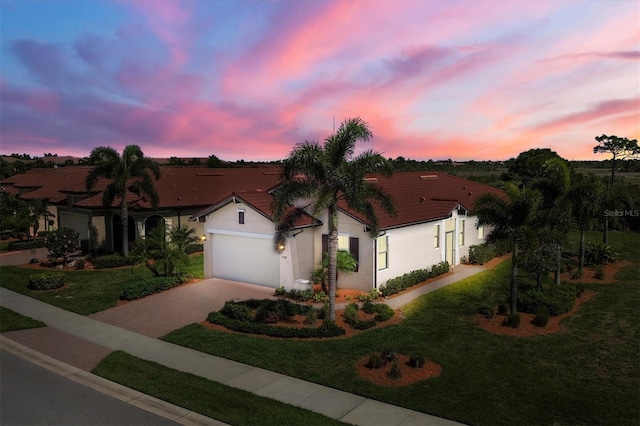 view of front of house with a lawn and a garage