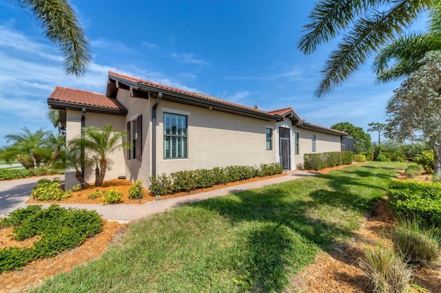 view of side of home featuring a lawn