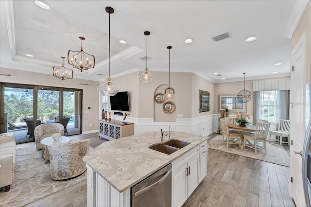 kitchen featuring white cabinetry, an island with sink, a healthy amount of sunlight, and stainless steel dishwasher