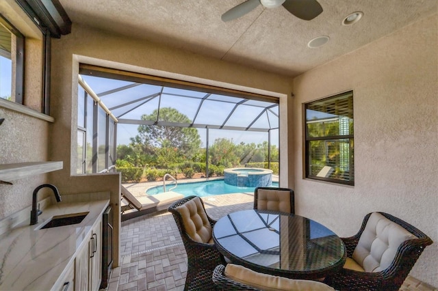 interior space with ceiling fan, a swimming pool, a wealth of natural light, and sink