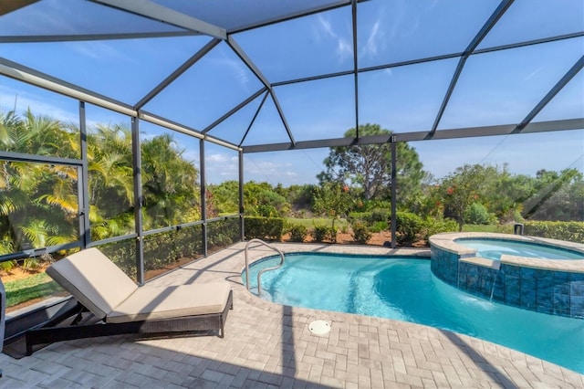 view of swimming pool featuring glass enclosure, an in ground hot tub, and a patio