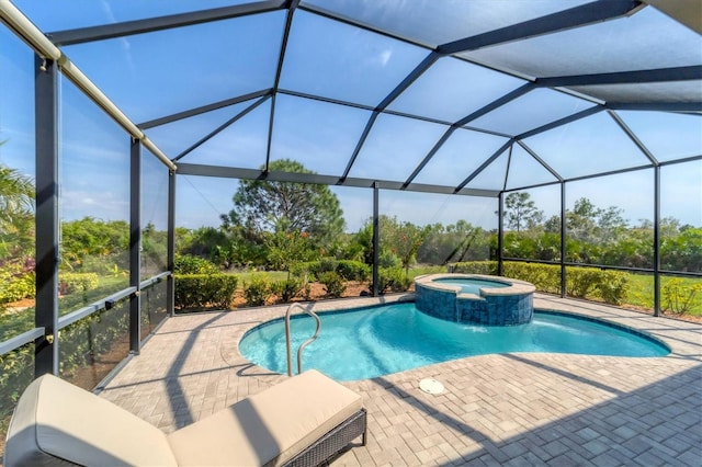 view of pool with an in ground hot tub, glass enclosure, and a patio area