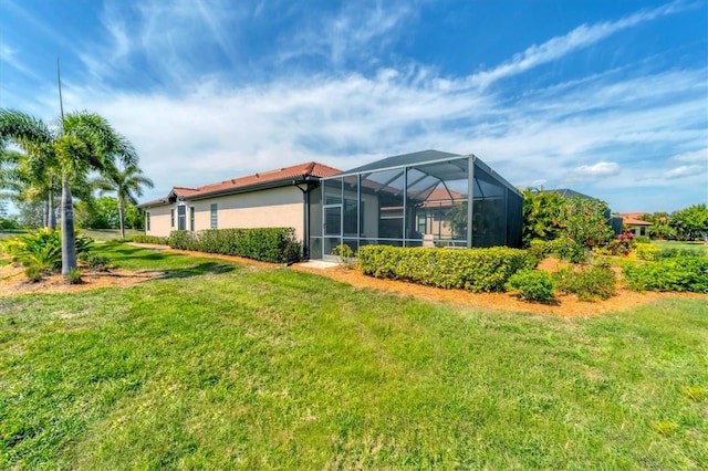 exterior space featuring a lanai and a lawn