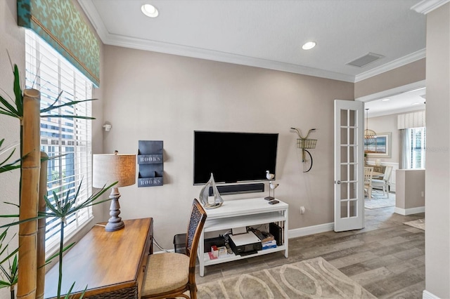 office with french doors, hardwood / wood-style flooring, ornamental molding, and a healthy amount of sunlight