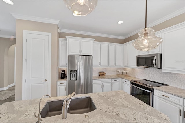 kitchen featuring light stone counters, white cabinets, and stainless steel appliances