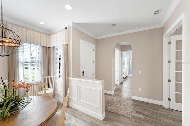 dining room featuring wood-type flooring and crown molding