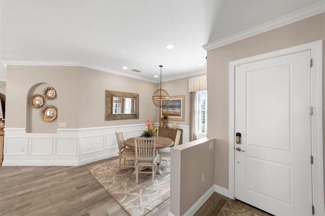 dining space featuring hardwood / wood-style floors and crown molding