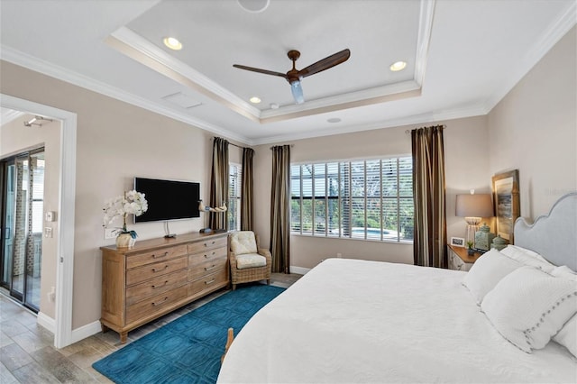 bedroom with a raised ceiling, crown molding, ceiling fan, and wood-type flooring